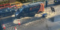Burst pipe turns road into 'lake' with water 'lapping against homes'